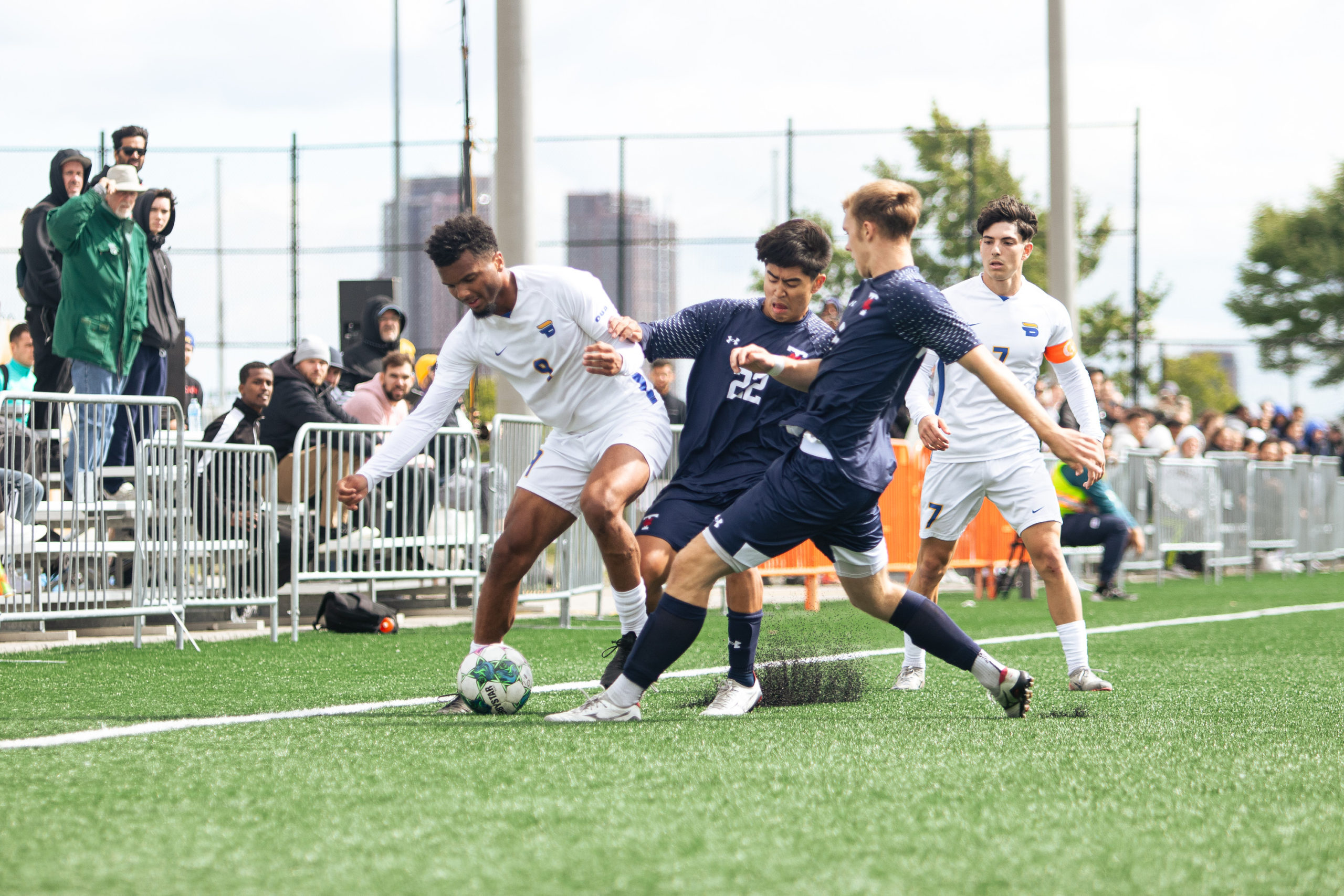 Some players from the TMU Bold soccer team disputing the ball against the U of T Varsity Blues