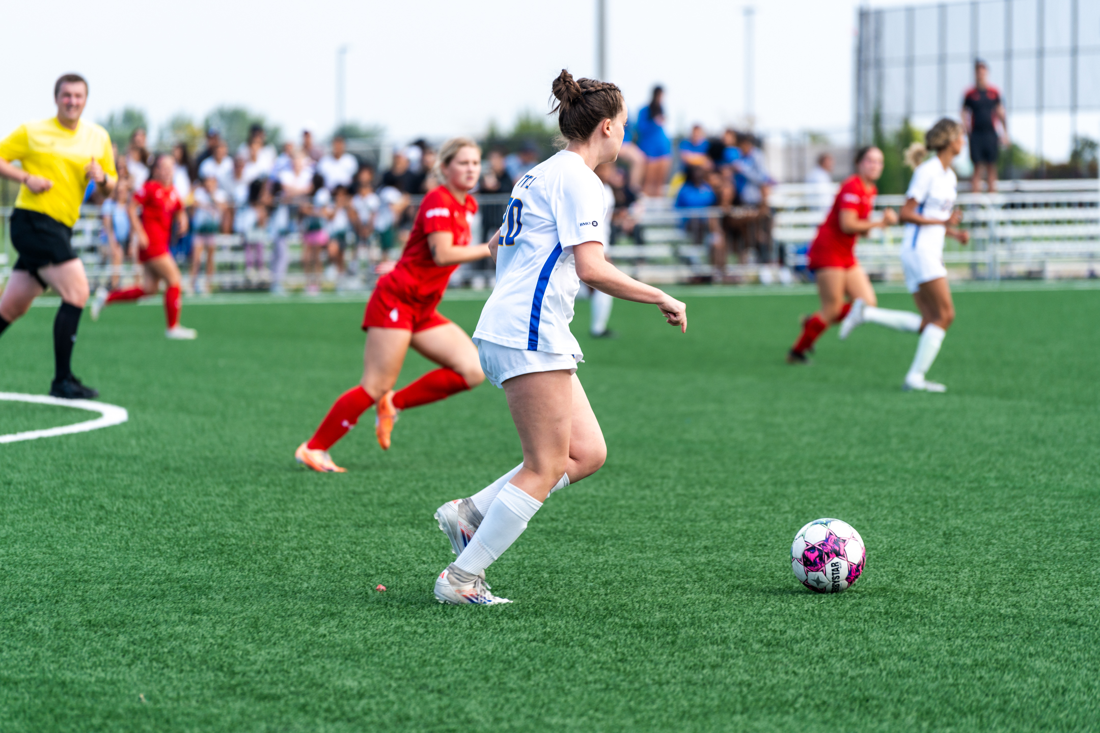 Allison Brayman grabbing the ball in the middle of the pitch