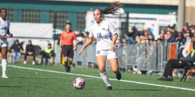 Lisamarie Arangio controls a soccer ball near the sideline