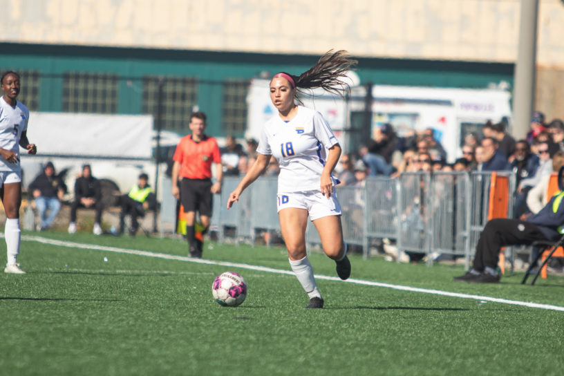 Lisamarie Arangio controls a soccer ball near the sideline