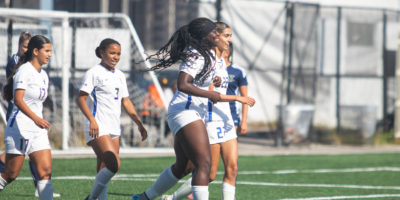 Members of the TMU Bold women's soccer team congratulate Aalayah Lully after she scored a goal