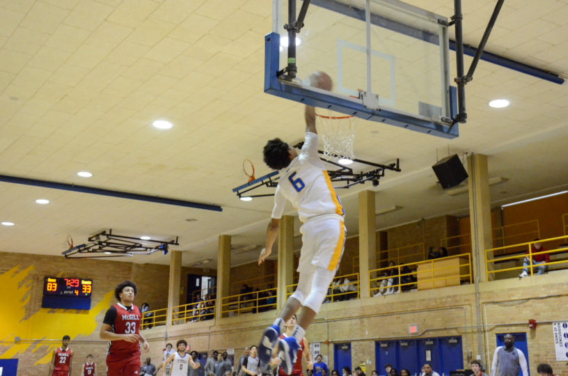 Landon Wright throws down a dunk against the McGill Redbirds