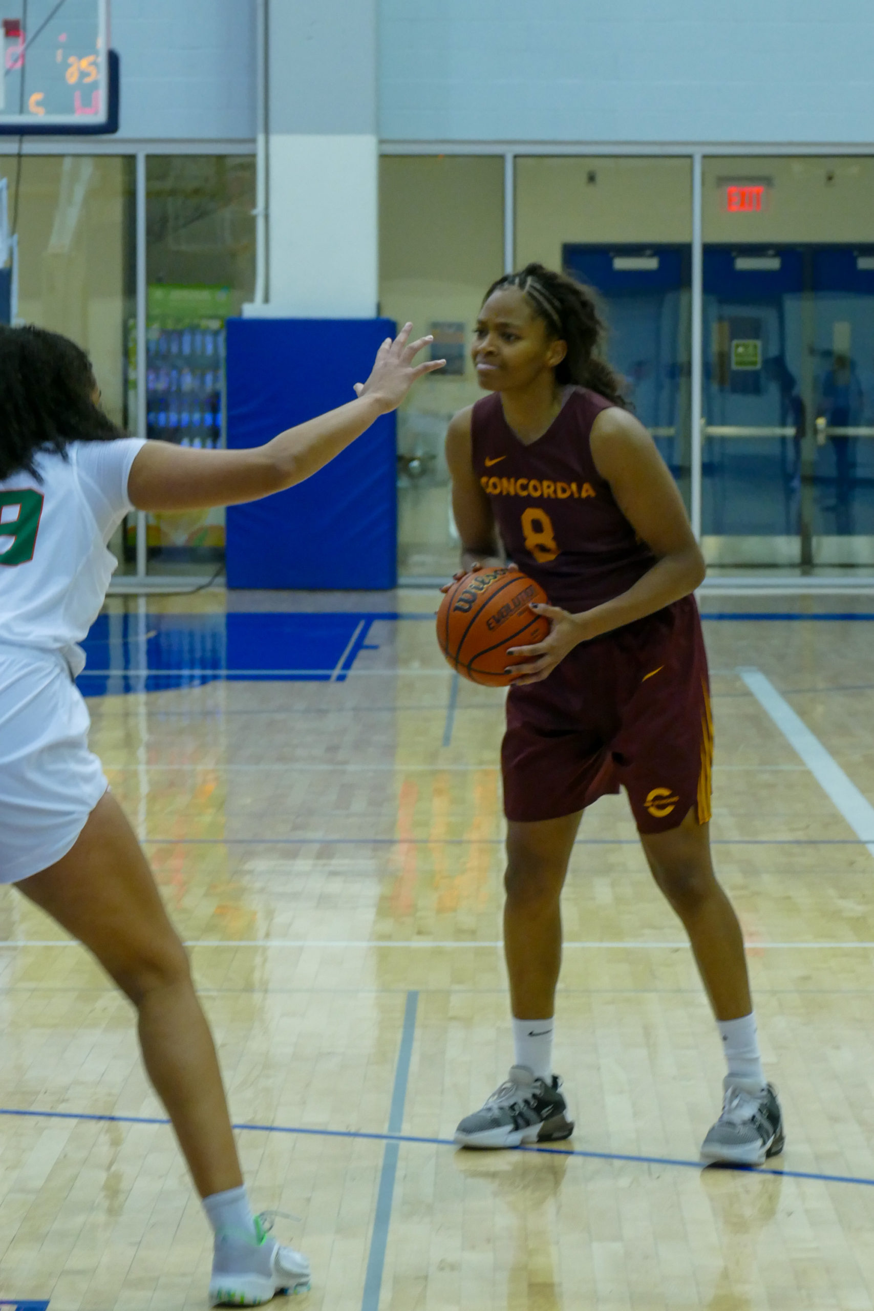 A Concordia Stingers player holds the ball in front of a Cape Breton Capers player