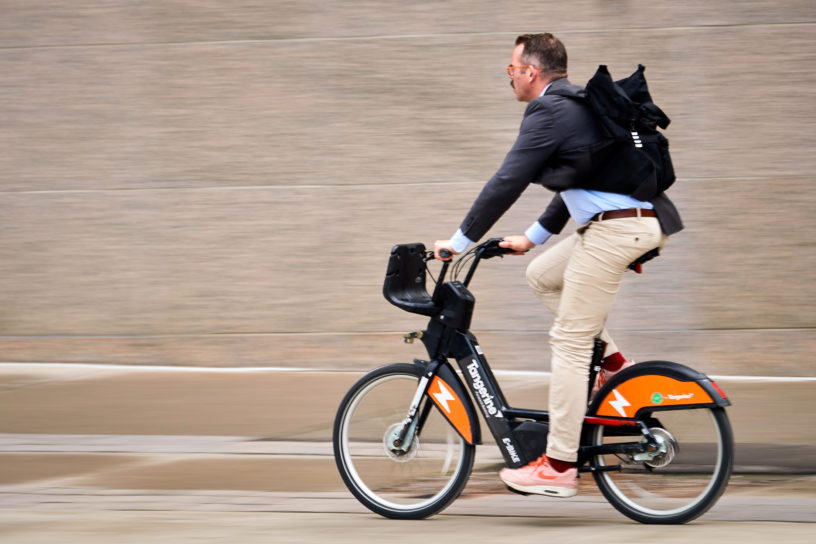 MAN BIKING FAST CITY BIKE