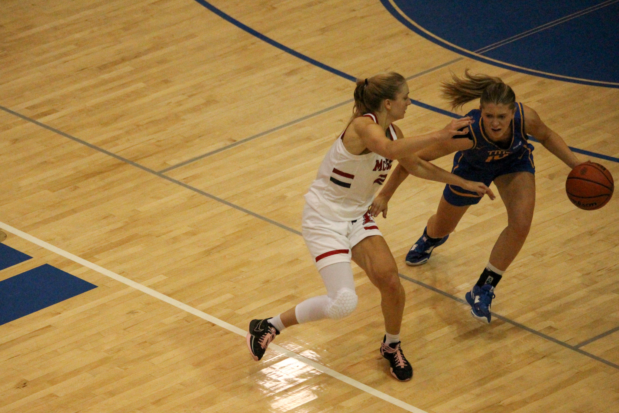 Kailie Hall dribbling the ball in the middle of the court