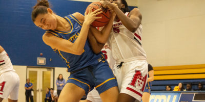 Hailey Franco-DeRyck disputing the ball against a McGill player