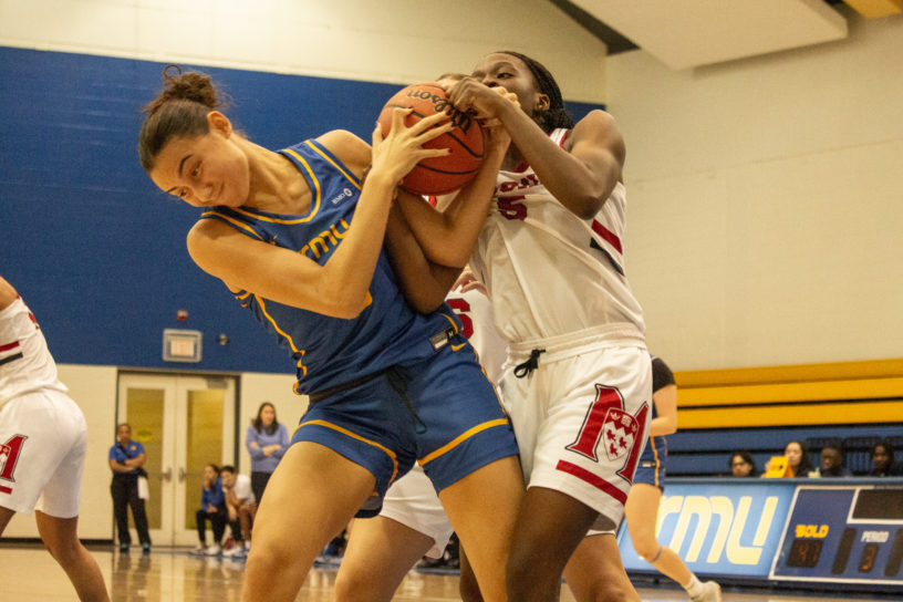 Hailey Franco-DeRyck disputing the ball against a McGill player