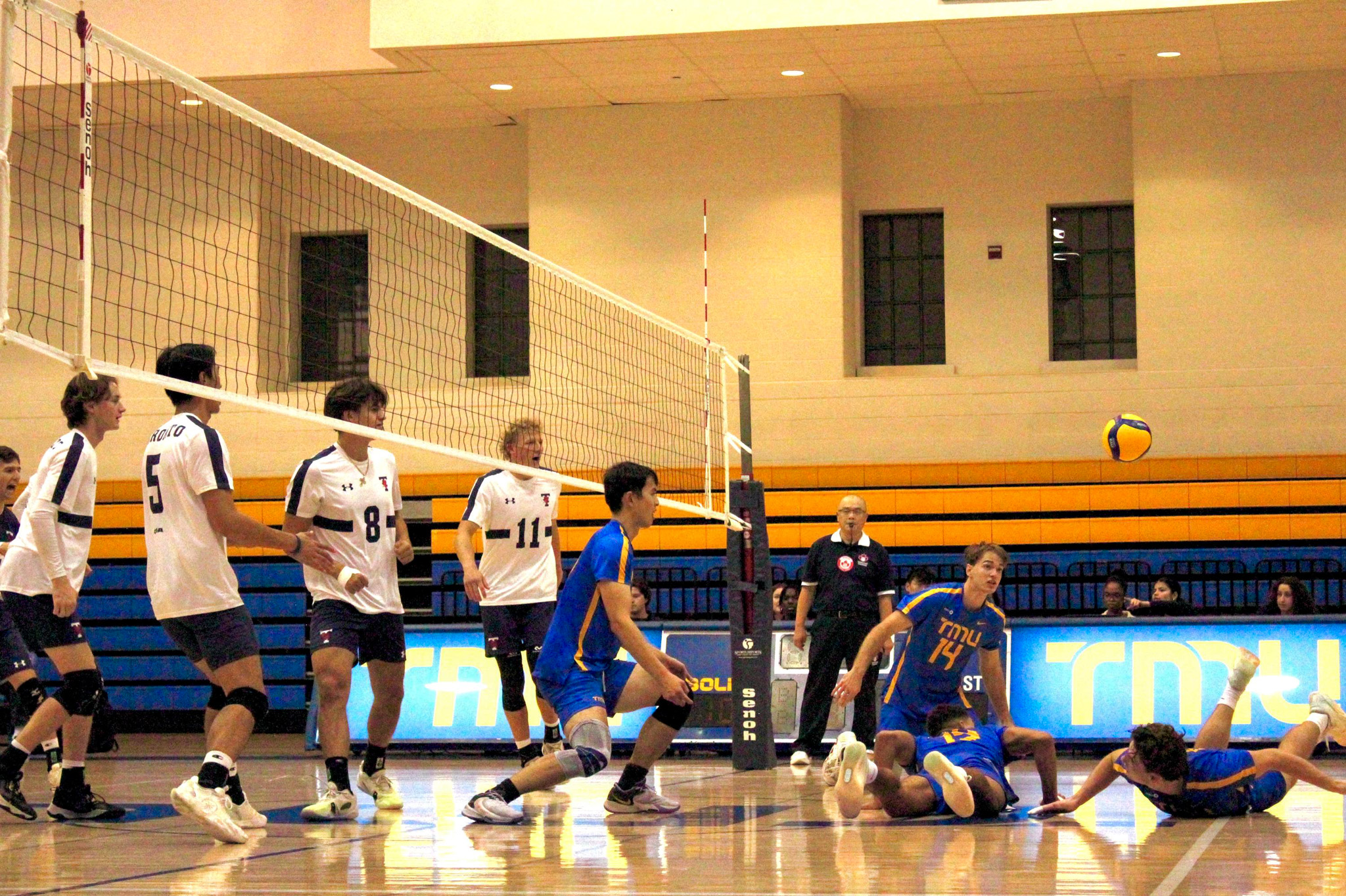 the TMU Bold men's volleyball team struggling to keep the ball off the ground