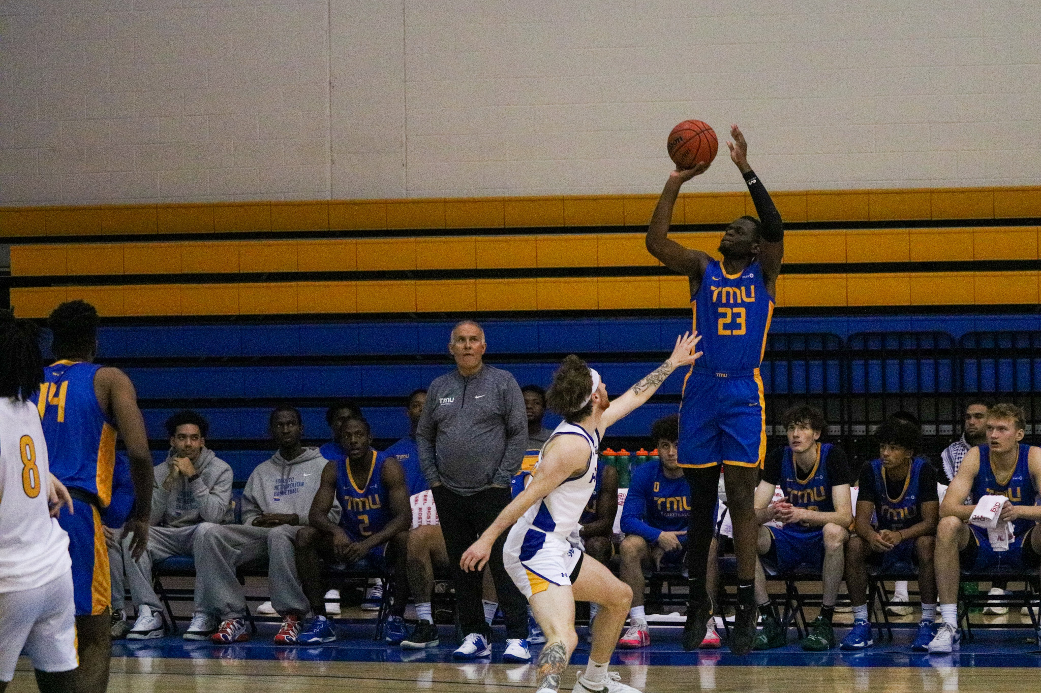 Michael Kayembe shooting a three-pointer 