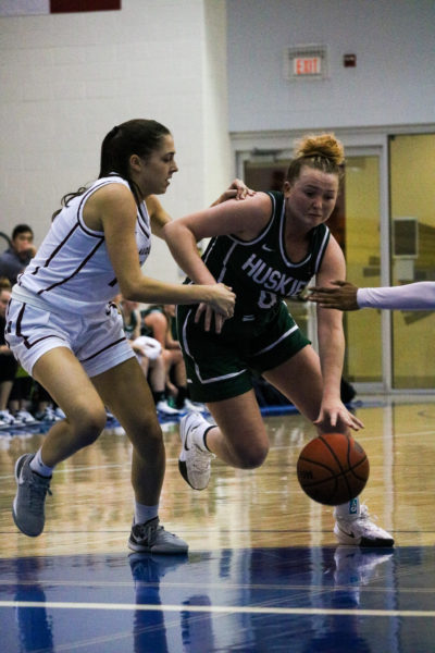 A Saskatchewan Huskies player dribbles through McMaster Marauders defenders