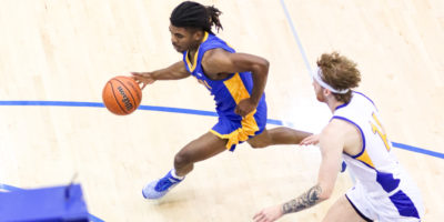 Maxine Louis-Jean dribbles past a UBCO player in full stride