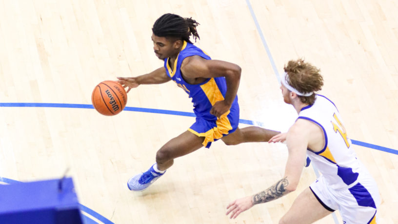 Maxine Louis-Jean dribbles past a UBCO player in full stride