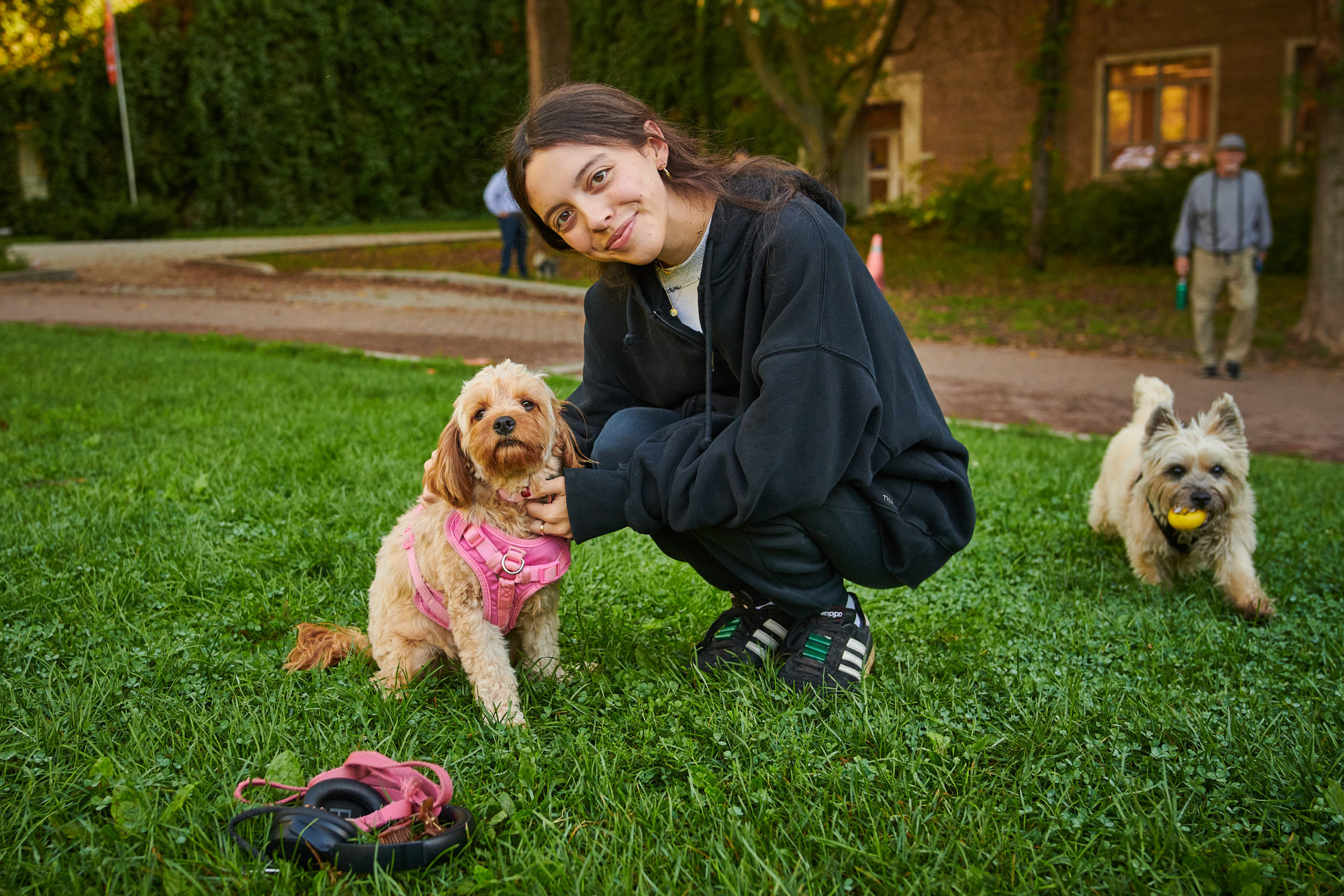 A dog owner smiles at the camera with their dog.