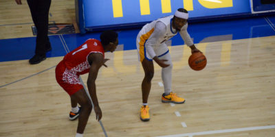 Javier Gilgeous-Glasgow dribbles the ball as he approaches an Algoma defender near the scorer's table