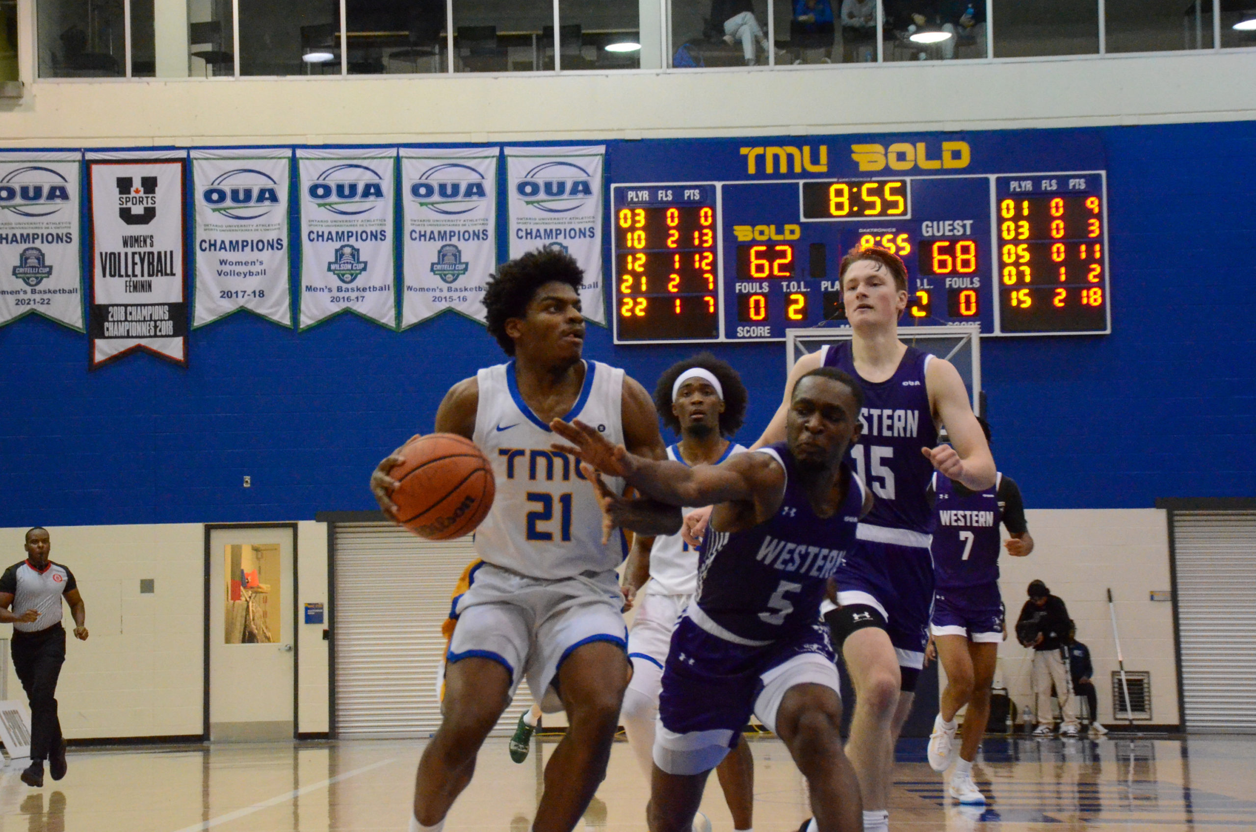 Gabriel Gutsmore prepares for a layup against Mustangs defenders