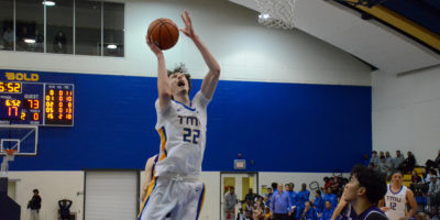 Aidan Wilson makes a face as he goes for a layup