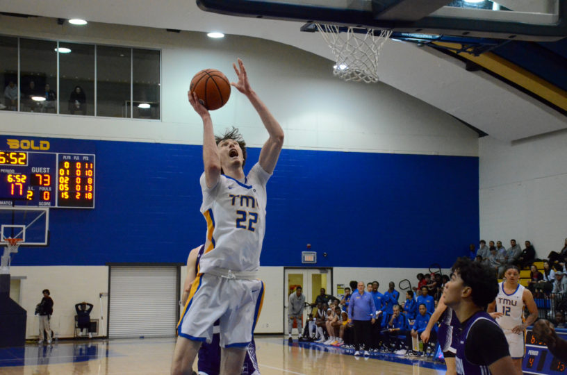 Aidan Wilson makes a face as he goes for a layup