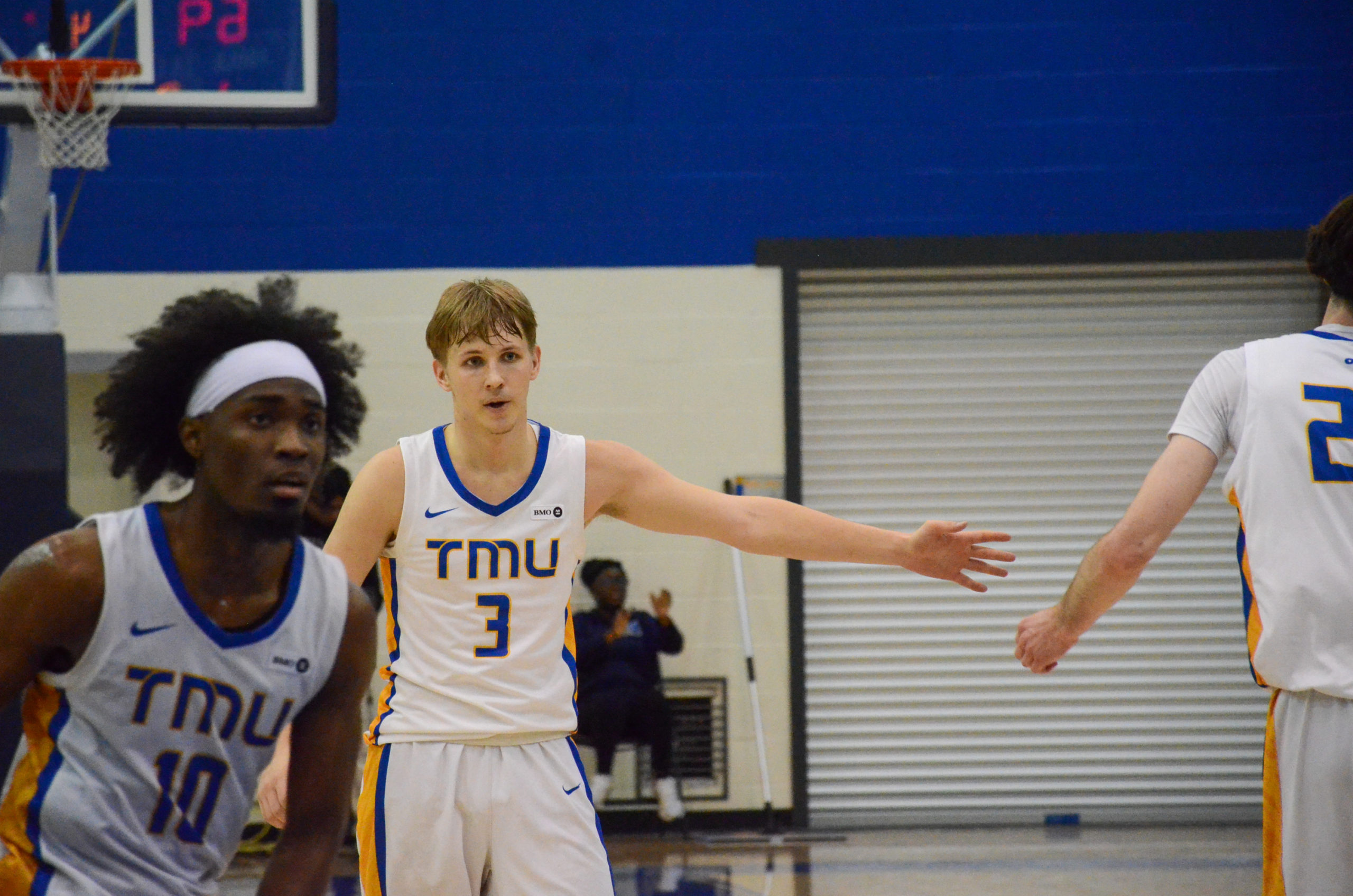 Kevin Toth holds his arm out for a high five from Aidan Wilson