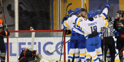 TMU Bold players celebrate a goal as the UQTR goalie gets up off the ice in his net