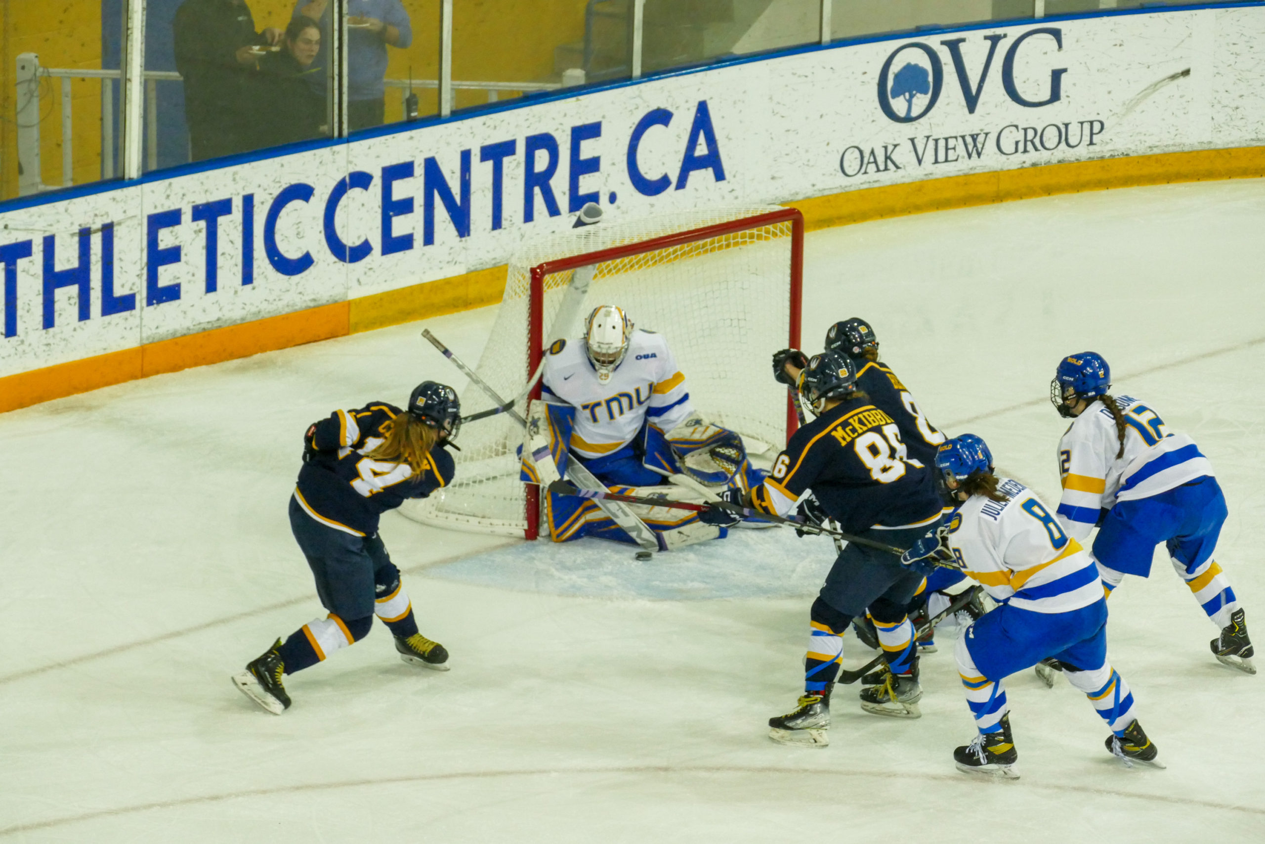 A windsor player shooting the puck at Alexia Stratos