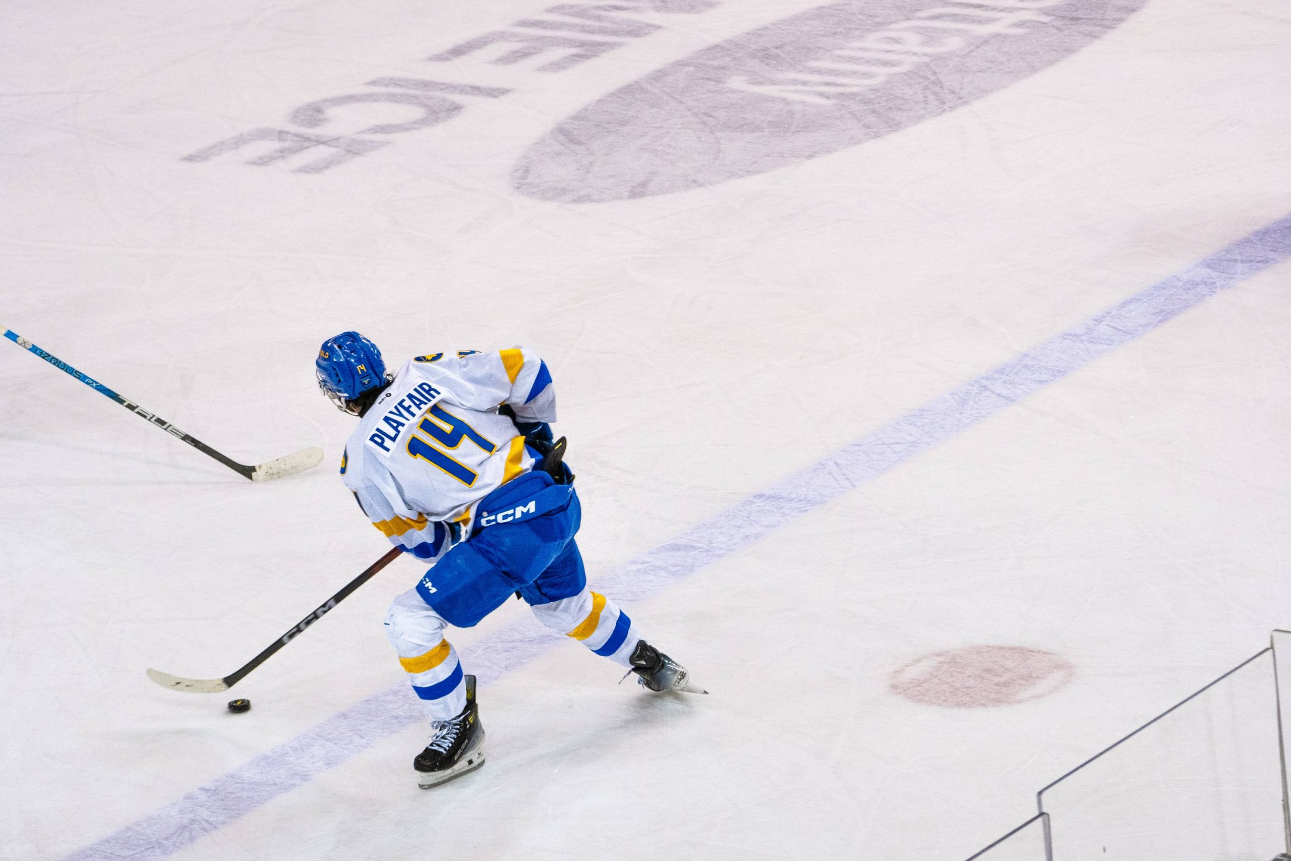 Captain Chris Playfair with the puck and skating