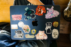 A blue laptop decorated with stickers.