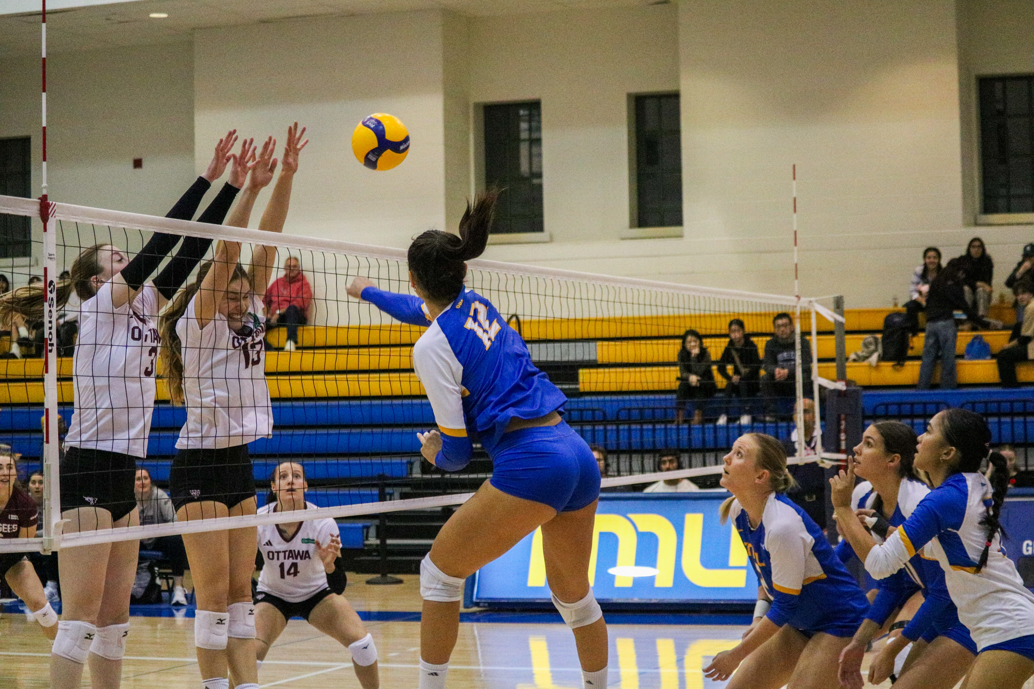 Scarlett Gingera hitting the ball at the line of defence from Ottawa