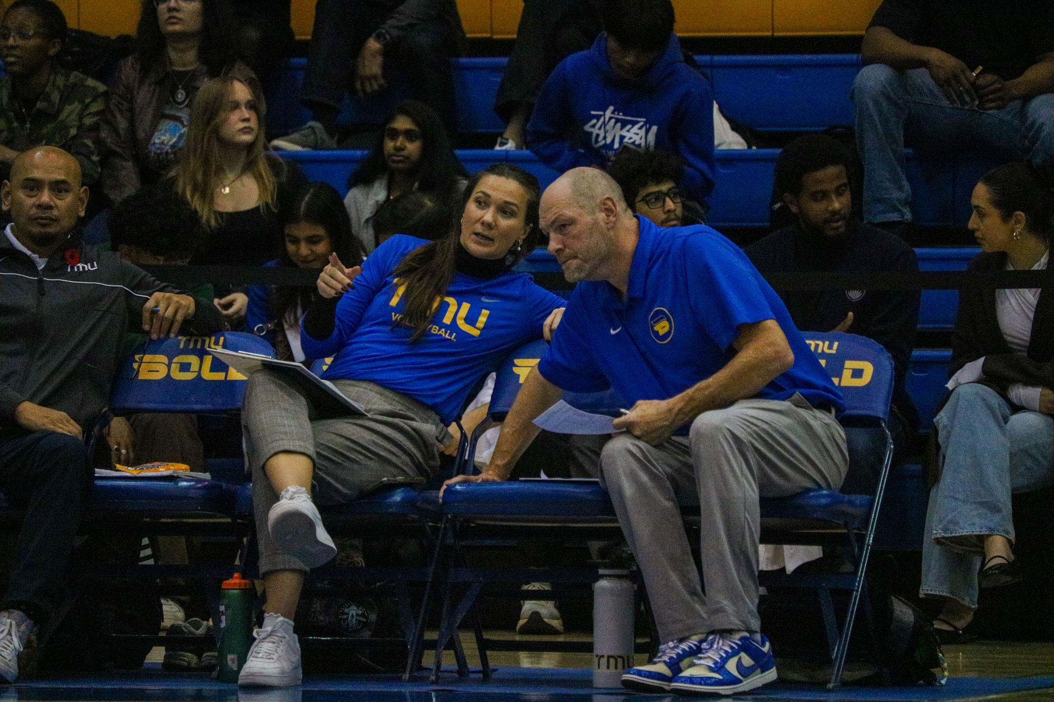 Julie Gordon and Dustin Reid talking in the middle of the game