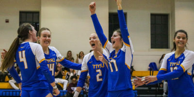 The TMU Bold women's volleyball team celebrating a point