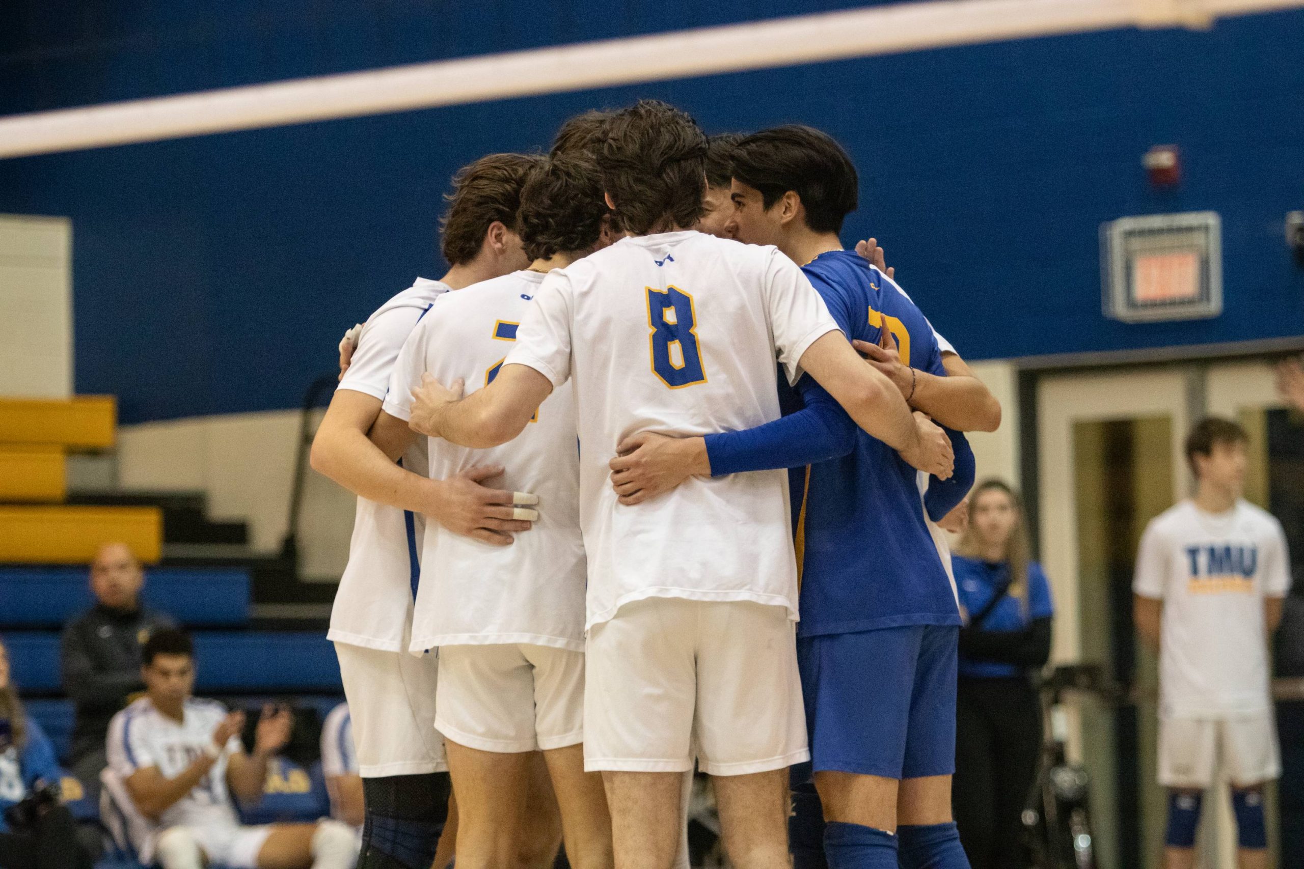 The TMU Bold men's volleyball team celebrating the win