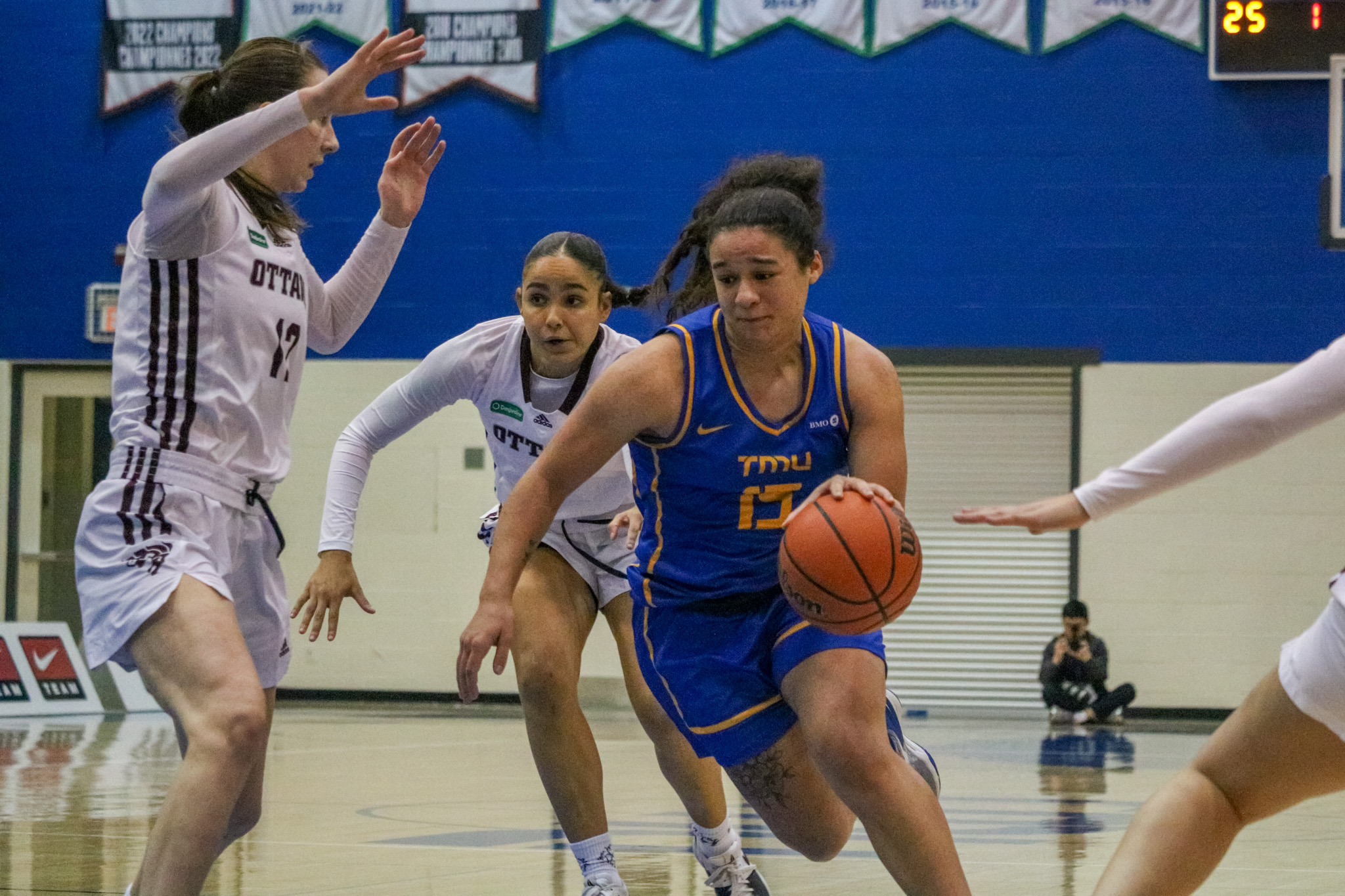 Kait Nichols dribbling in between Ottawa players