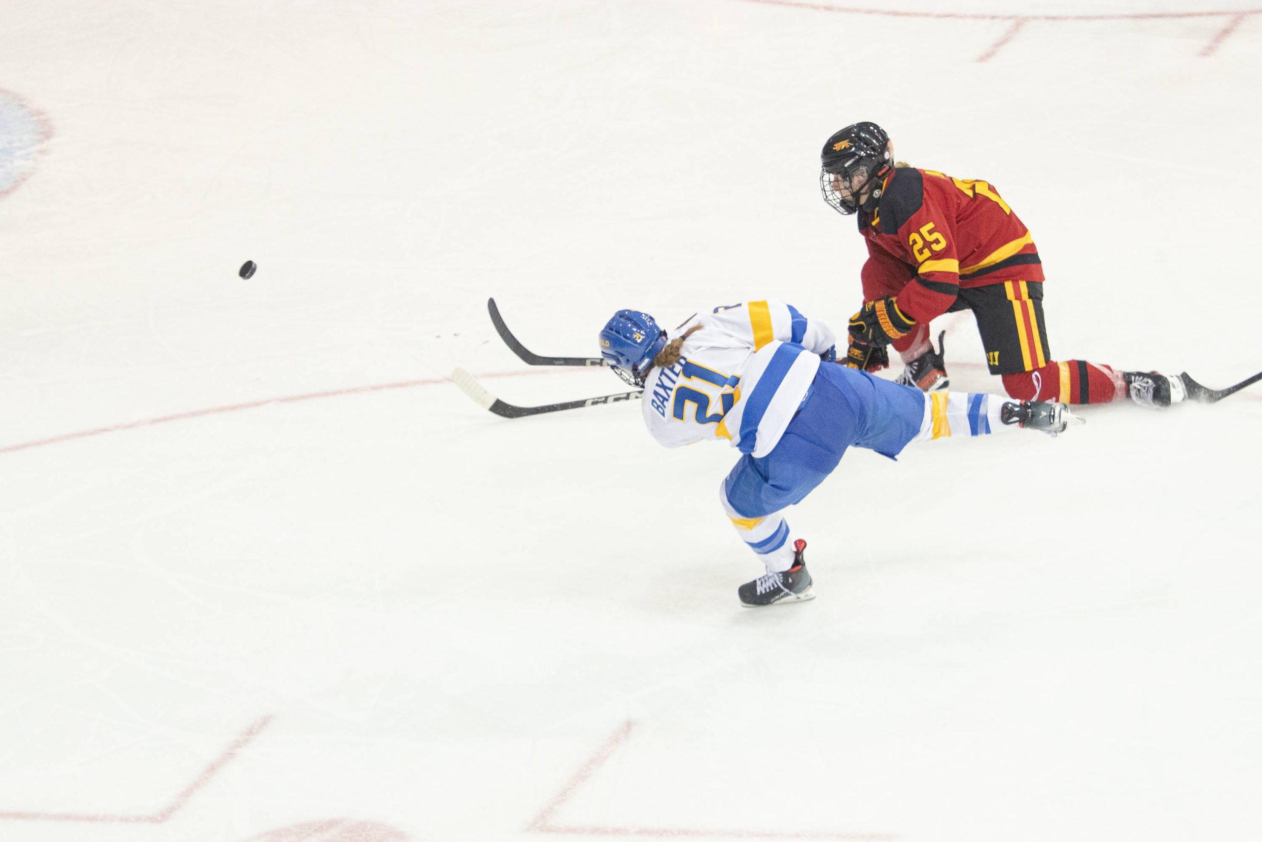 Emily Baxter shooting the puck