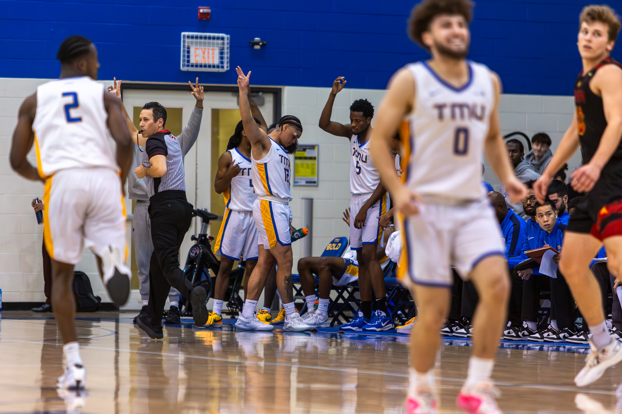 The TMU Bold bench celebrating after Angelekos scored