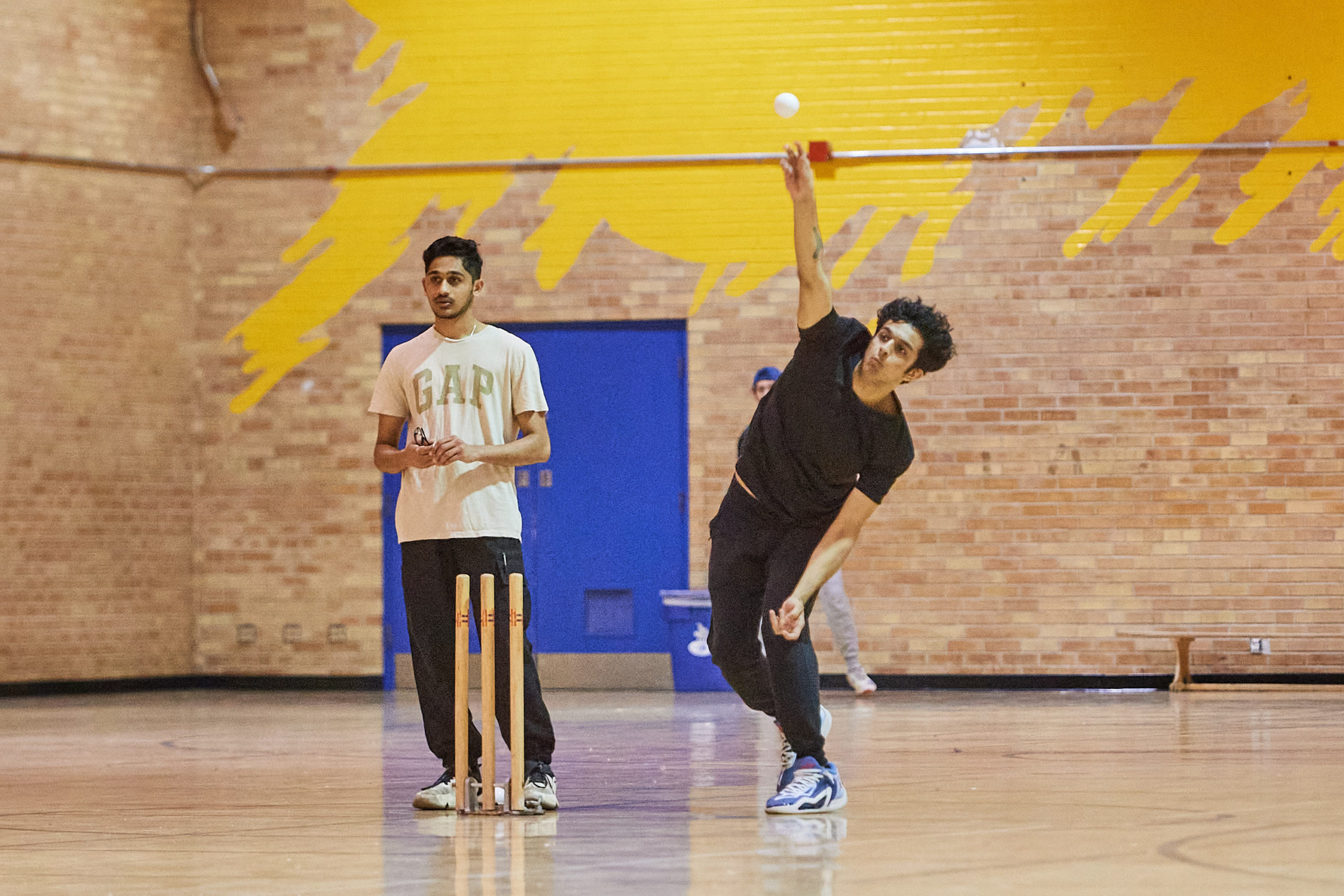 someone throwing the ball over his shoulder in the upper gym at Kerr Hall