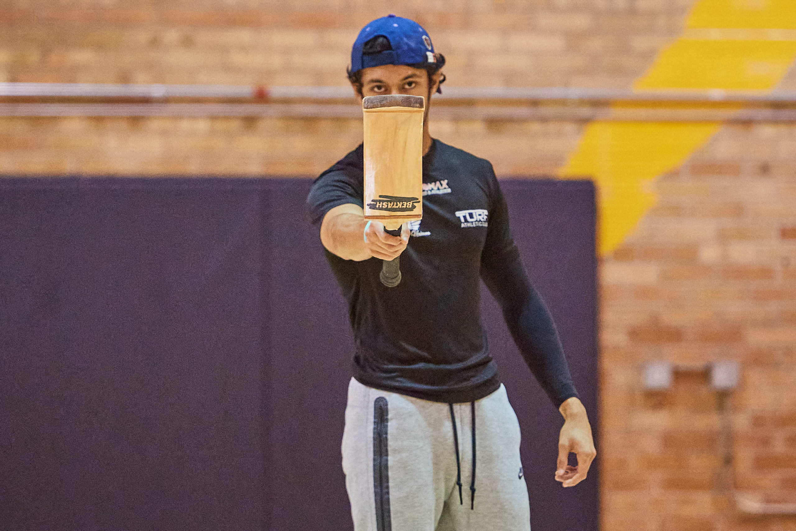 Hrishik Mehta pointing with his bat at the camera