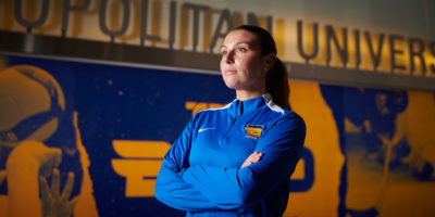 A portrait of Emily Porteous looking up and away from the camera in the hallway at the Mattamy Athletic Centre