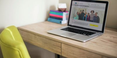 A laptop sits on a desk, open to the Black Student Success and Engagement page on the Toronto Metropolitan University website.