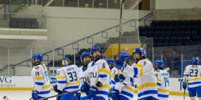 The TMU Bold women's hockey team celebrating a win