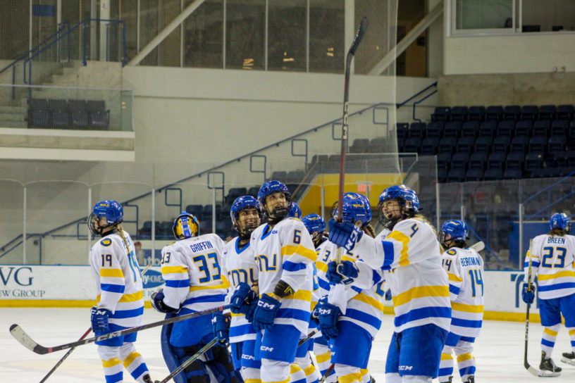 The TMU Bold women's hockey team celebrating a win