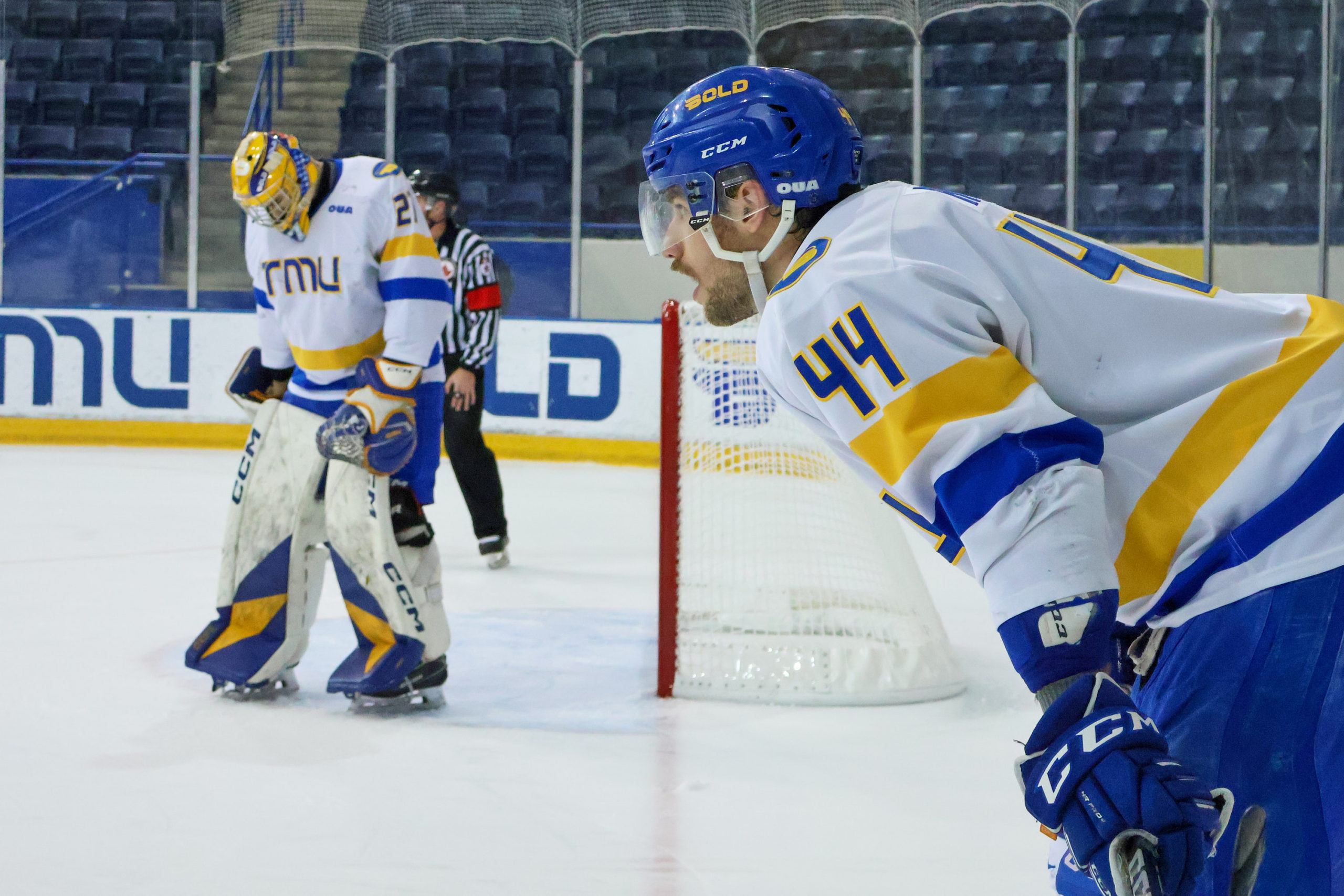 Joe Rupoli leans over his stick in the corner near Kai Edmonds' net