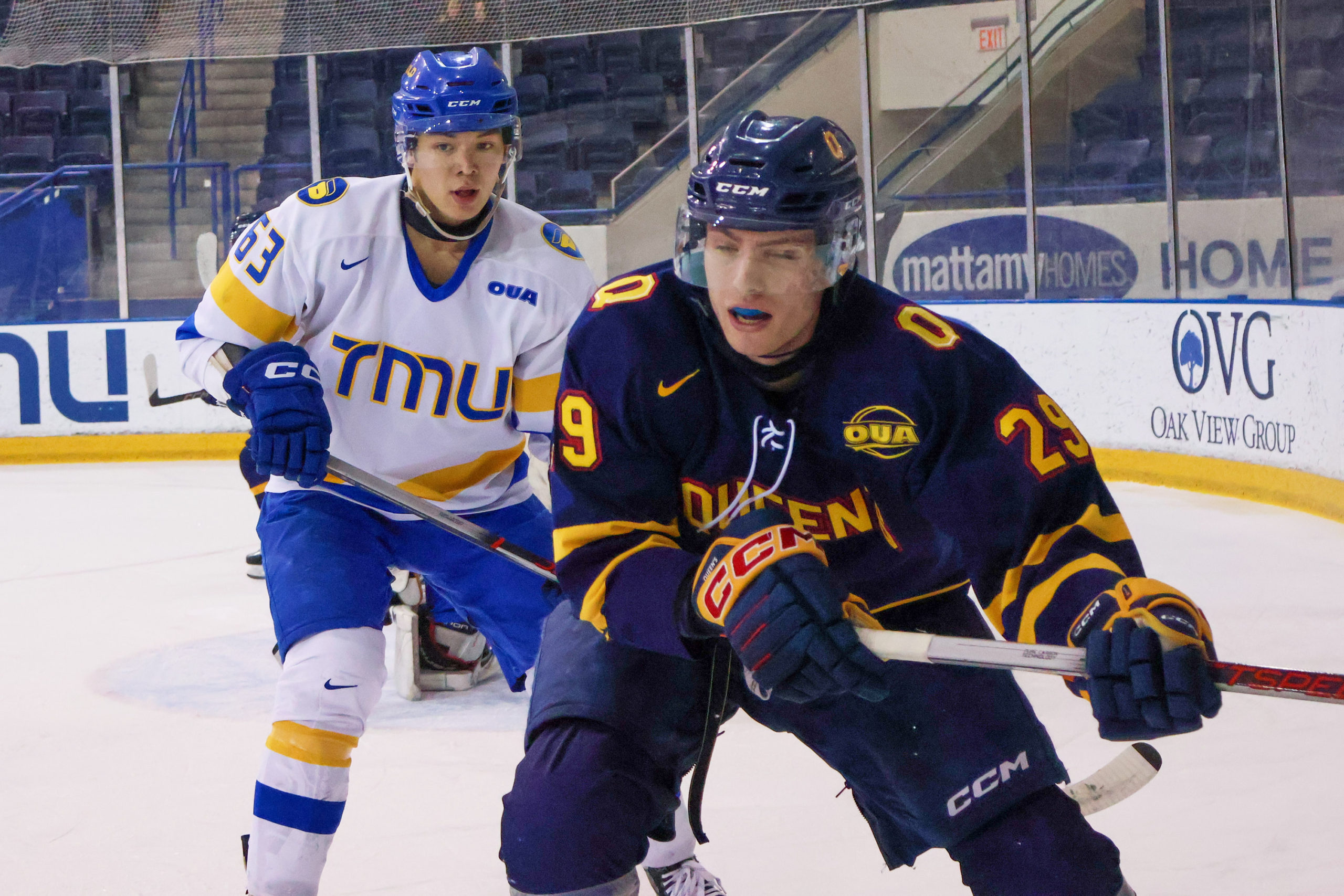 Liam Ross approaches a Queen's player approaching the glass