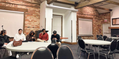 tmsu members sit in corner of empty room with chairs and tables