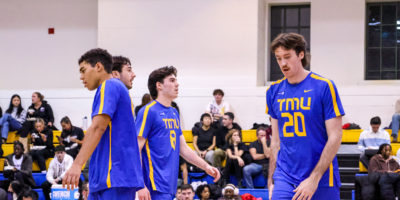 The TMU Bold men's volleyball team looking down after the defeat