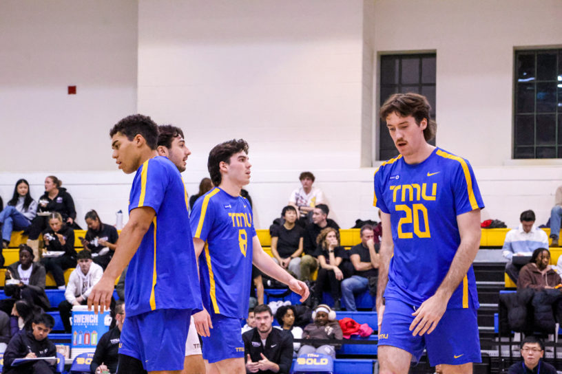 The TMU Bold men's volleyball team looking down after the defeat