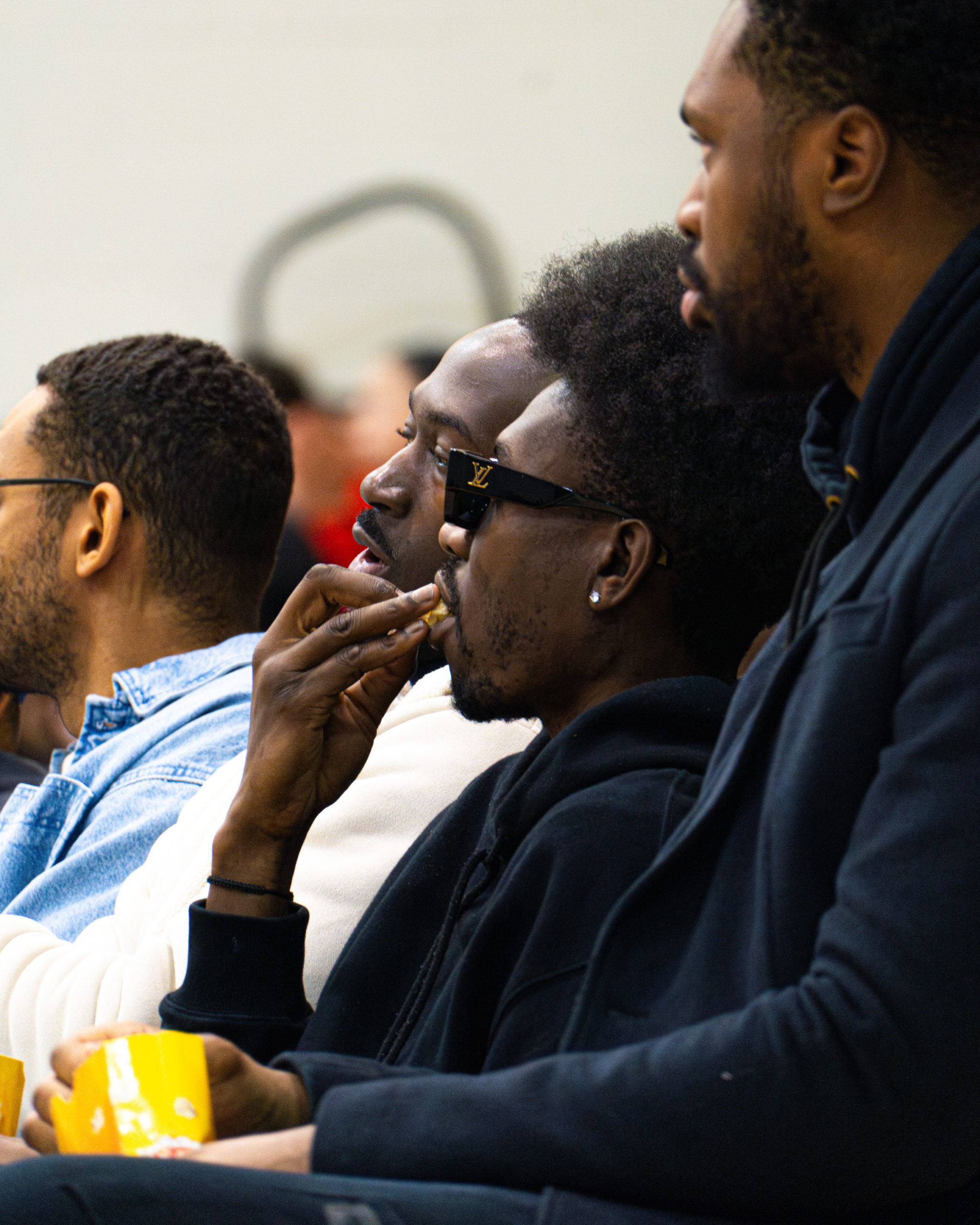 Chris Boucher eats popcorn courtside at a TMU Bold game