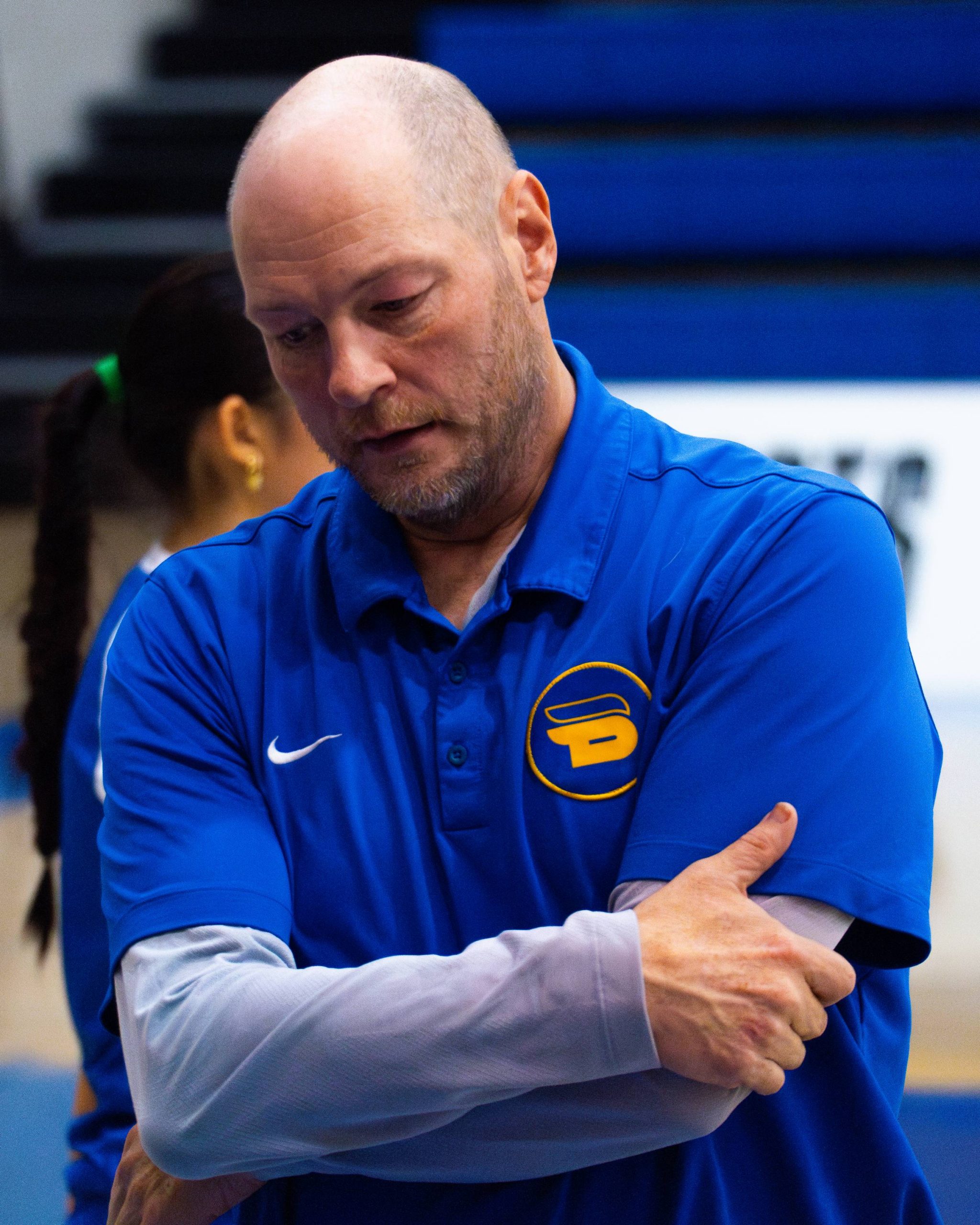 head coach Dustin Reid looking down after the loss