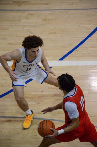 Greg Angelakos defends a Brock Badgers player while having a cut above his eye