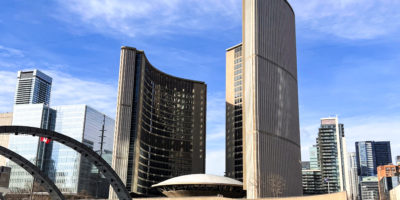 A photograph image of City Hall with a view of the skating rink