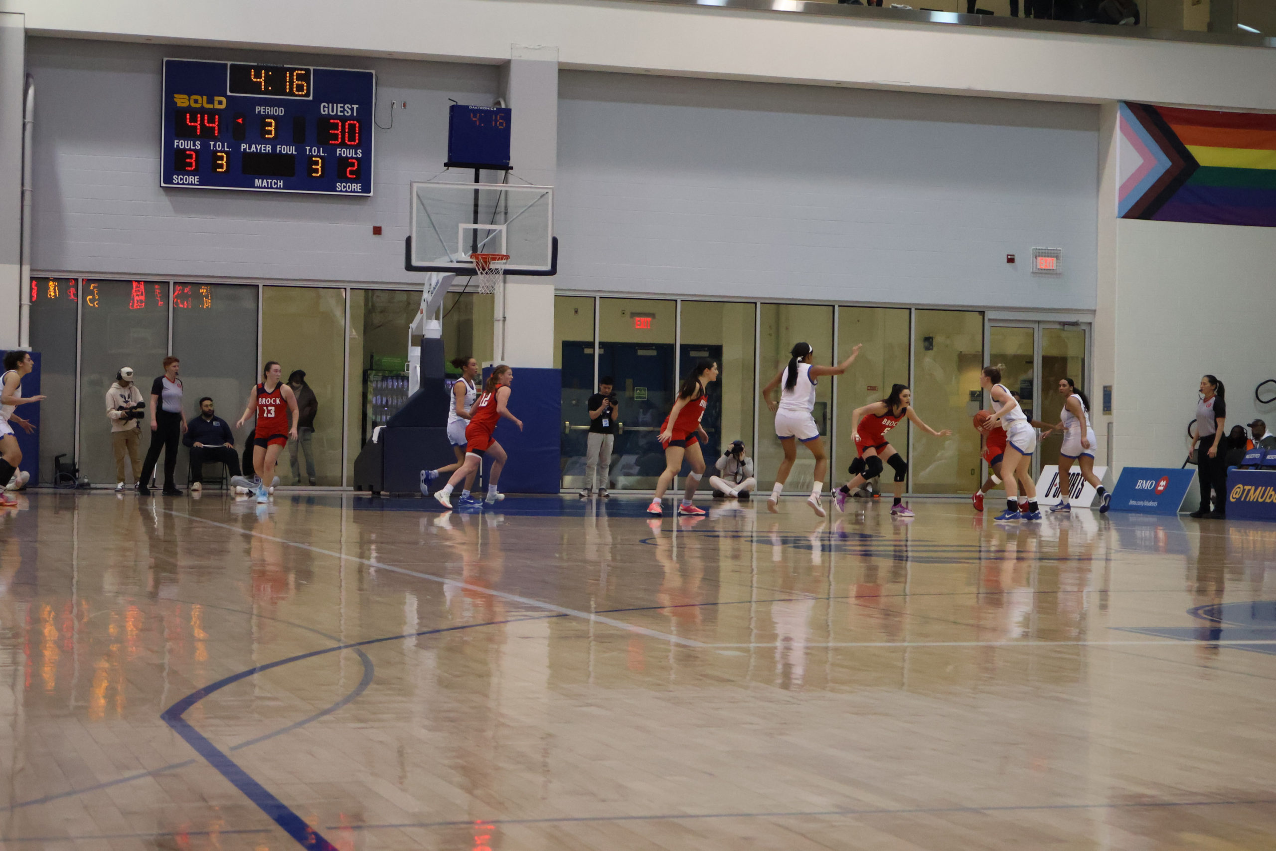 A wide view photo of a women's basketball game between the TMU Bold and Brock Badgers