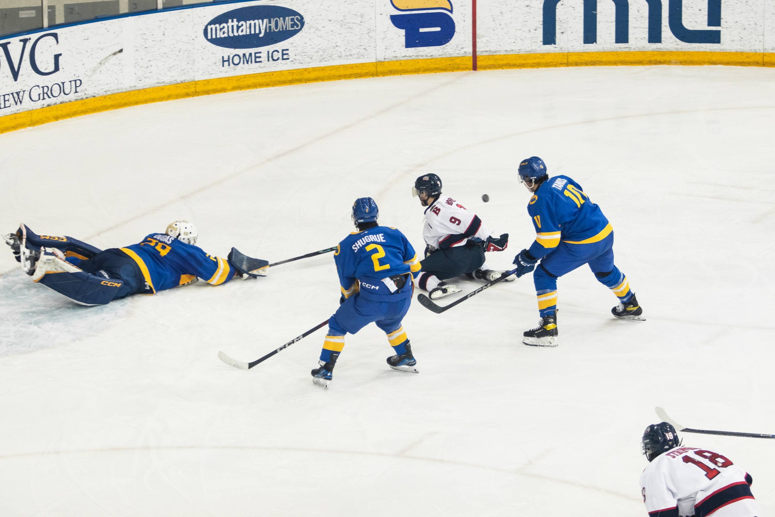 Ryan Dugas does a diving poke check against a Brock Badgers player